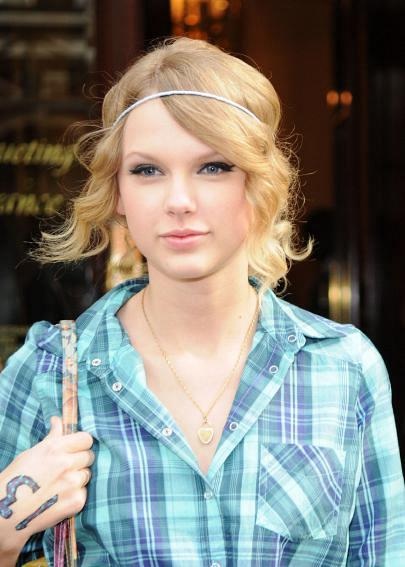 Taylor Swift in a light blue plaid shirt