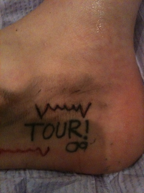 vampire fangs added to her tour tattoo