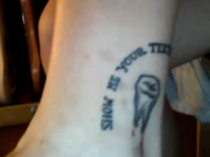 Sierra Kusterbeck tooth tattoo