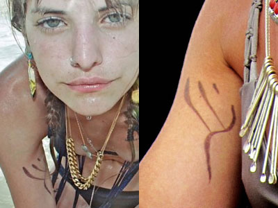 On the inside of her right arm is the mark from the movie Willow