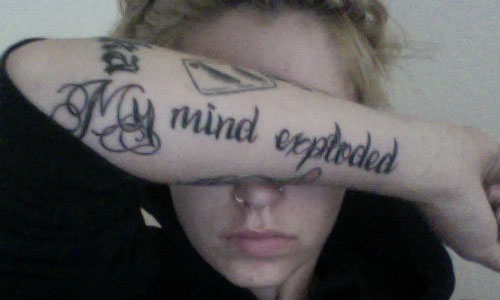  has My Mind Exploded written along the side of her right forearm
