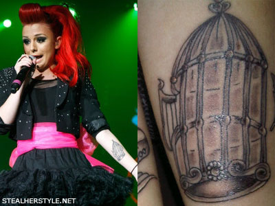 On her forearm is the birdcage which matches the bird on her right arm
