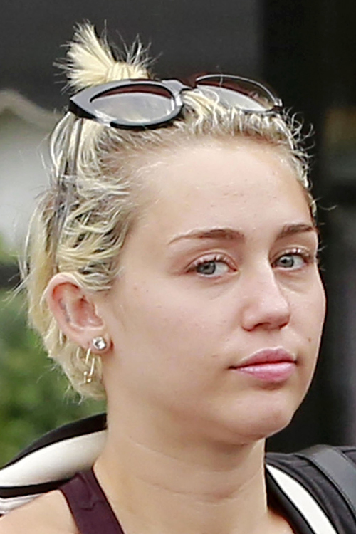 Miley Cyrus Wavy Golden Blonde Bun Dark Roots Messy Hairstyle Steal