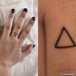 Sierra Kusterbeck triangle finger tattoo