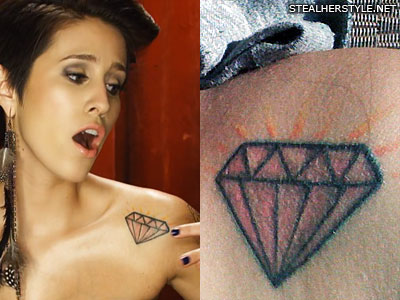 DEV has a pink diamond tattoo on the left side of her chest.
