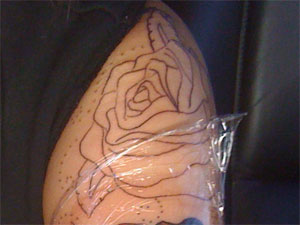 Dev's unfilled rose tattoo