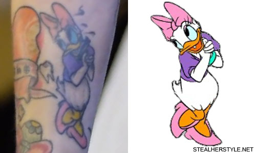 Fine line style Daisy Duck tattoo located on the wrist.