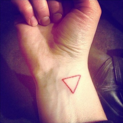 Small red upside down triangle tattoo on the wrist - Tattoogrid.net