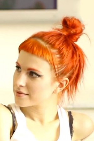 Hayley Williams Straight Orange Baby Bangs Bun Messy Bun Hairstyle Steal Her Style