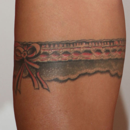 Beautiful Red Bow Garter Tattoo On Thigh