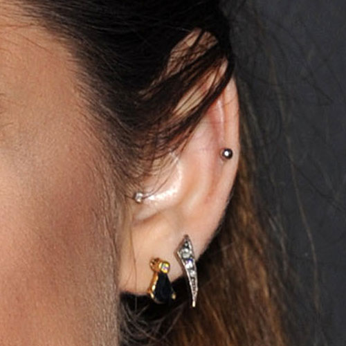 Lucy Hale has four piercings in her left ear: one tragus, one auricle, and ...