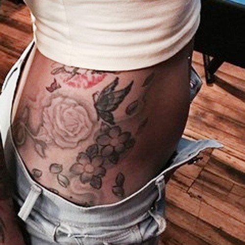 The tattoo is a vibrant and intricate design spanning across the Hip and  Side. It features