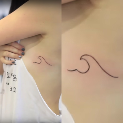 Minimalistic style heart and wave tattoo located on the