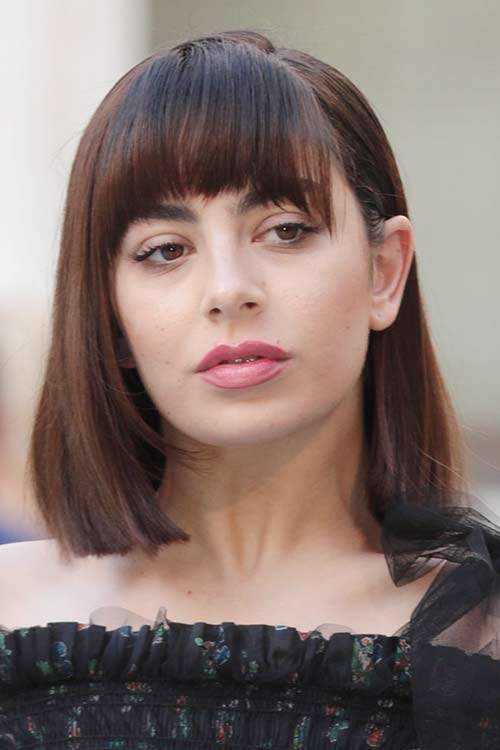 Charli XCX Straight Dark Brown Blunt Cut, Curved Bangs Hairstyle