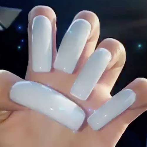 Danielle Bregoli wears long squared nails painted in light blue polish. 