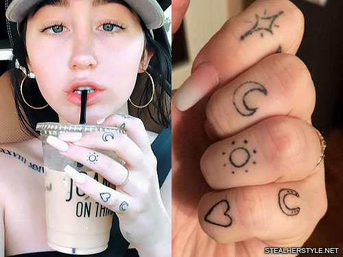 Sun and moon tattoo located on the fingers