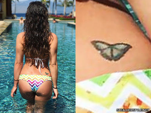 A tiny butterfly tattoo on the hip