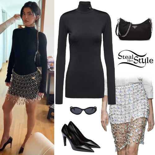 Who made Kylie Jenner's gold jewelry, watch, white stripe strapless top,  black stripe skirt, and gray sneakers?